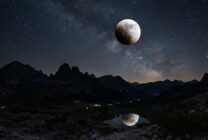 Partial lunar eclipse showing Moon with dark shadow covering portion of its surface against starry night sky