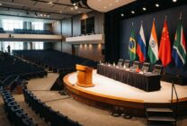 Conference hall prepared for BRICS summit with member nation flags displayed on stage