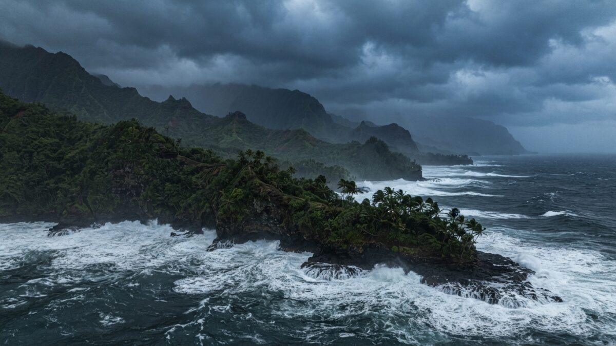 Storm clouds gathering over Hawaiian coastline as hurricane approaches