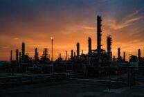 Oil refinery infrastructure at dusk showing industrial petroleum processing facilities