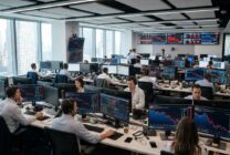 Trading floor screens showing declining stock futures and rising oil prices