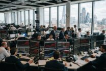 Financial trading floor with screens showing rising bond yields and market data