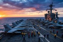 U.S. aircraft carrier flight deck with military jets during operations at sea
